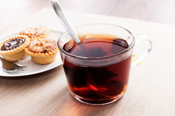 Tea time with hot tea and dessert tarts