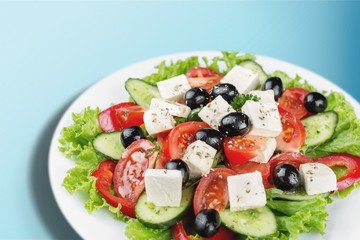 Greek salad with fresh vegetables on background