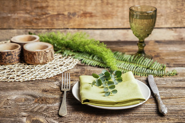 Beautiful table setting with floral decor on wooden background