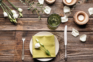 Beautiful table setting with floral decor on wooden background