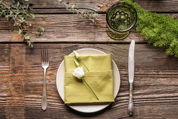 Beautiful table setting with floral decor on wooden background