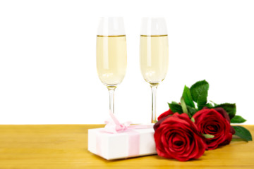 Glasses of champagne with rose flower and Valentines day gift box Isolated.