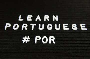 Learn Portuguese, POR abbreviation, simple sign on black background, great for teachers, schools, students