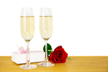 Glasses of champagne with rose flower and Valentines day gift box Isolated.