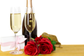 Glasses of champagne with rose flower and Valentines day gift box Isolated.