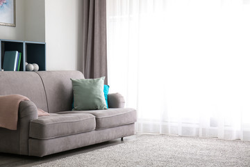 Interior of beautiful room with comfortable sofa