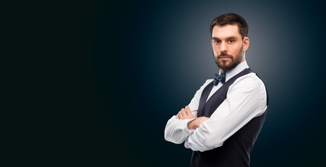 Fototapeta premium people concept - serious man in white shirt, waistcoat and bowtie over black background