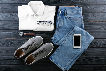 Set of stylish male clothes and accessories on wooden background