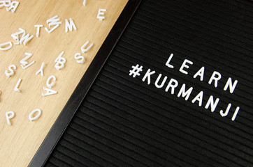 Learn Northern Kurdish Kurmanji language, KUR abbreviation, simple sign on black background, great for teachers, schools, students