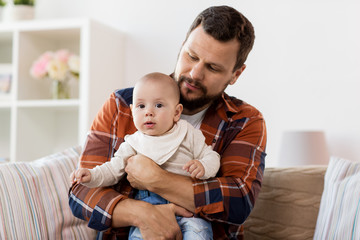 family, parenthood and people concept - happy father with little baby boy at home