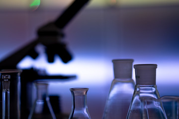 Empty chemical glassware on color background. Group of laboratory empty flasks   on color...