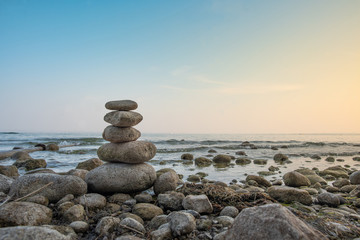 Fototapeta premium Stacked stones in balance on the lakeside, Lake Garda, Italy