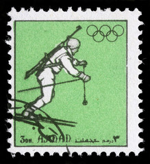 A stamp printed in Ajman shows biathlonist, circa 1972