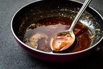 Preparing Red Sauce with Frying Melted Butter and Spices in Pan / Cooking Recipe with Spoon.