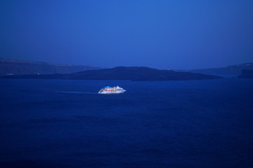 Obraz na płótnie Canvas Colorful night view of a cruise ship in Oia, Santorini