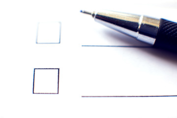 Checklist form with a pen on white paper. Checkbox concept.