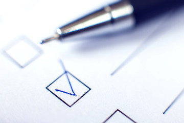 Checklist form with a pen on white paper. Checkbox concept.