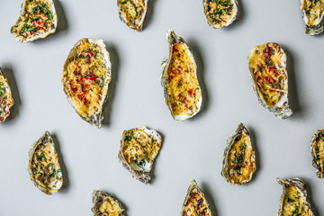 Tasty baked oysters on grey background