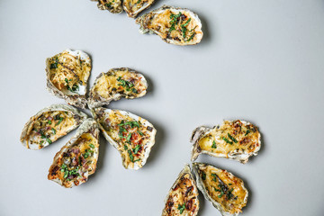 Tasty baked oysters on grey background