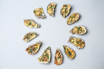 Frame made of tasty baked oysters on grey background