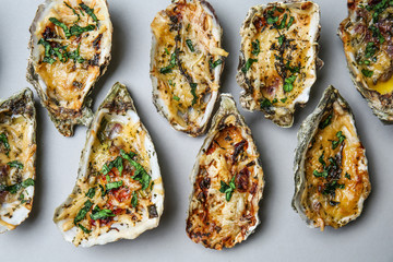 Tasty baked oysters on grey background