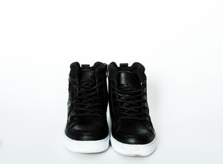 black leather sneakers on a white background