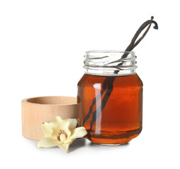 Bottle of vanilla extract on white background