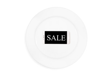 Mobile phone with word of sale served on empty plate. Concept. Isolated