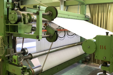A roll of paper installed in a typographic machine.