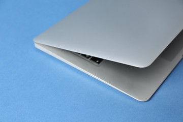 Modern laptop on color background, closeup