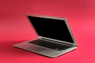 Modern laptop on color background