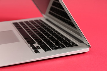 Modern laptop on color background, closeup