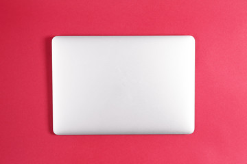 Modern laptop on color background