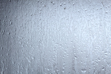 many drops of water on misted glass