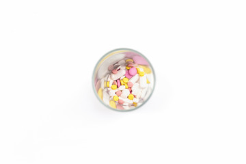 glass full of colorful medicines,pills, vitamins or supplements. The concept of addiction treatment