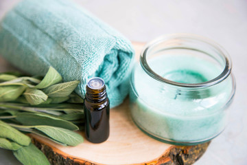 Spa still life set with candle and essential oil bottle