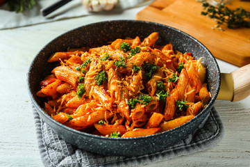 Tasty pasta with tomato sauce and cheese in frying pan