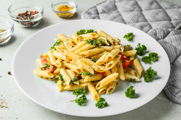 Tasty pasta with sauce and vegetables on plate
