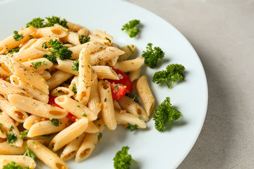 Tasty pasta with sauce and vegetables on plate, closeup
