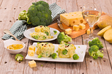 Potato gratins with broccoli florets.