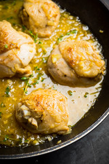 Roasted chicken in a pan with cream sauce and spices. Selective focus.