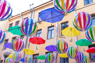 umbrellas and balloons flying through the streets of the city