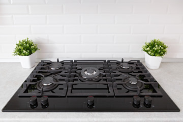 Gas stove in the kitchen is installed in the countertop.