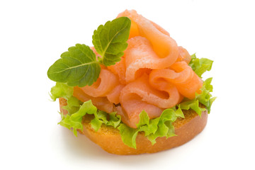Bread with fresh salmon fillet isolated on white background, top view.