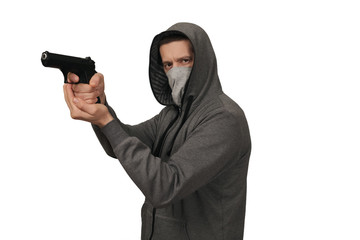 The man in a sports jacket and in a mask shoots with the gun