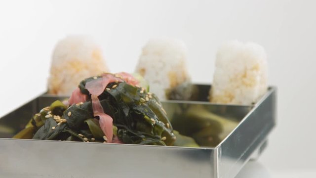 rolling bento with onigiri and salad