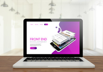 laptop front end development website on wooden desktop