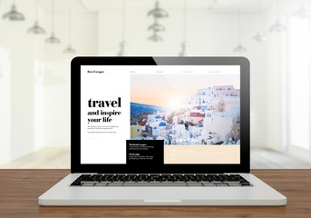 laptop travel blog on wooden desktop