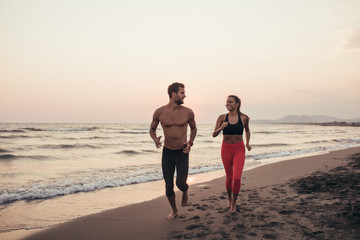 Couple Jogging by the Sea