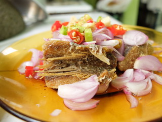 Salted fish salad, sprinkled with chilli and red onions 